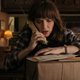 Joyce Byers (Winona Ryder) talks on the phone, looking worried.